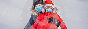 Mom son ride on an inflatable winter sled tubing wear medical masks due to the COVID-19 coronavirus. Winter fun for the