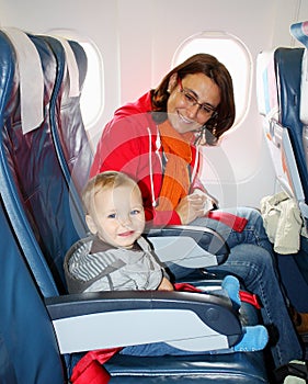 Mom and son sit inside an aircraft and ready to take off