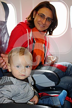 Mom and son sit inside an aircraft and ready to take off