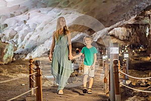 Mom and son tourists in Hang Sung Sot Grotto Cave of Surprises, Halong Bay, Vietnam. Traveling with children concept