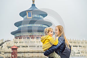 Mom and son travelers in the Temple of Heaven in Beijing. One of the main attractions of Beijing. Traveling with family