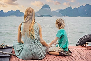 Mom and son travelers is traveling by boat in Halong Bay. Vietnam. Travel to Asia, happiness emotion, summer holiday