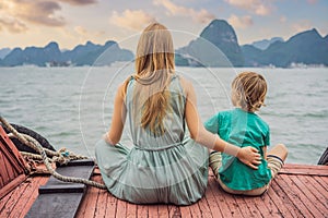 Mom and son travelers is traveling by boat in Halong Bay. Vietnam. Travel to Asia, happiness emotion, summer holiday