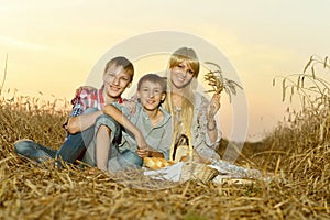 Mom with sons on wheat field