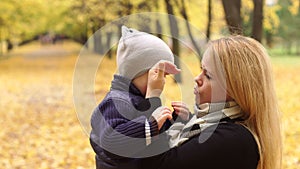 Mom soothes her son who was crying in autumn Park.