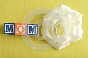 Mom spelled with alphabet blocks