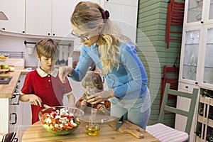 Mom sprinkle the salad with herbs.