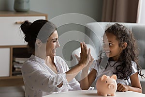 Mom teach daughter save money giving high five feel happy