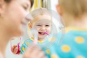 Mom teaches baby brushing teeth