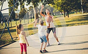 Mom teaches kids to have a sporting life.