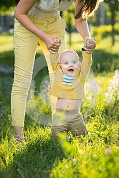 Mom teaches son walking grass photo