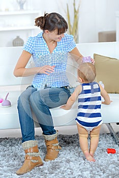 Mom teaching baby to walk