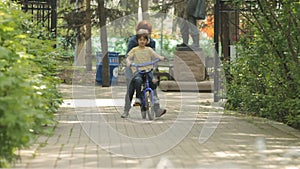 Mom Teaching Child to Ride a Bike