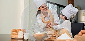 Mom teaching son for cooking food. Mother and kid daily lifestyle at home. Asian family together