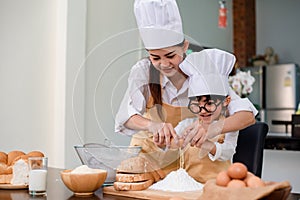 Mom teaching son for cooking food. Mother and kid daily lifestyle at home. Asian family together