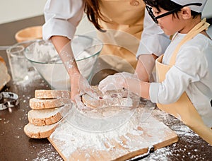 Mom teaching son for cooking food. Mother and kid daily lifestyle at home. Asian family together