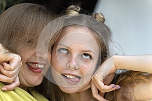 Mom and teen daughter fool around and make faces