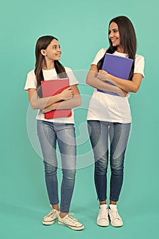 mom and teen girl study. private teacher and child holding copybooks. family help.