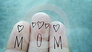 Mom text word written on fingers top with  Heart and love stickers , mothers Day greetings