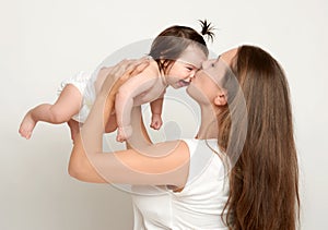 Mom throws baby baby and kiss, play and having fun