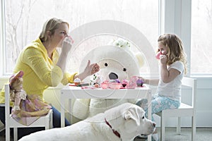 A mom and toddler having a tea party