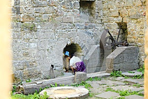 Mom with toddler observing broken iron mill gear in Dolsky mill