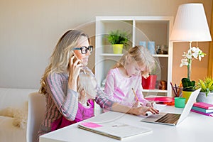 Mom with two daughters working from home