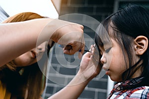 Mom was cutting her hair for her daughter at home