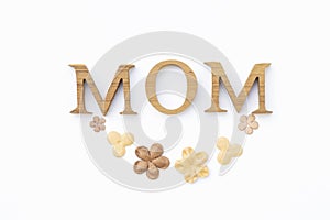 Mom wooden texture letter with paper flower isolate on white background