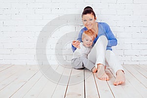 Mom and young boy sitting on the floor