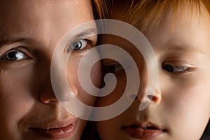 Mom and young redhead son close up. Closeness of mother and child concept