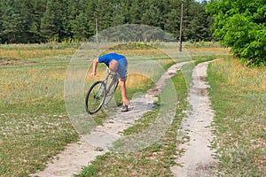 Moment of falling off of mature man on an ancient bicycle