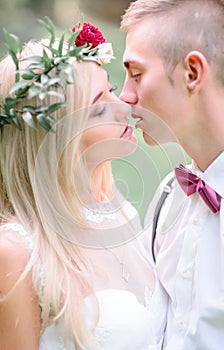 A moment before a kiss between beautiful young wedding couple