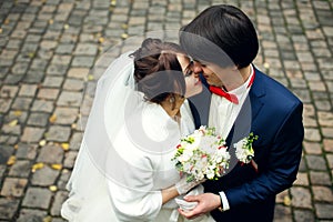 A moment before a kiss of joyful newlyweds