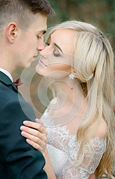 Moment before a kiss between stunning newlyweds