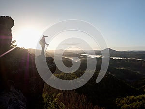 Moment of loneliness. Man on the rock empires watch photo