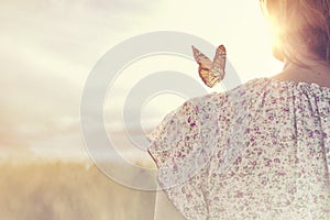 moment of meeting between a butterfly and a girl in the middle of nature