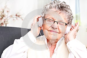 Moment of relaxation, rest grandmother listening to music.