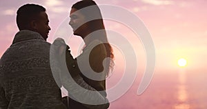 This moment should last forever. a happy young couple embracing each other at sunset on the beach.