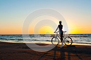 Moment in time. Sporty woman cyclist silhouette on multicolored