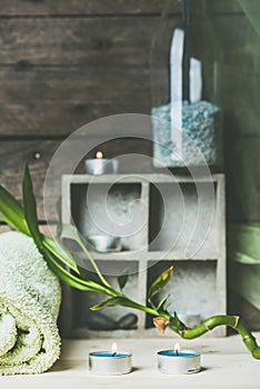 A moment to relax, natural spa and wellness background, raw wood, candles, blue and green colors