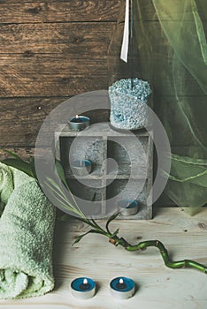 A moment to relax, natural spa and wellness background, raw wood, candles, blue and green colors