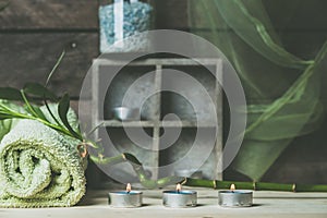 A moment to relax, natural spa and wellness background, raw wood, candles, blue and green colors