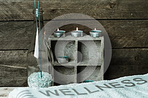 A moment to relax, natural spa and wellness background, raw wood, candles, blue and green colors