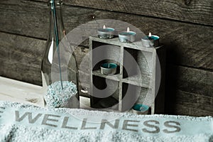 A moment to relax, natural spa and wellness background, raw wood, candles, blue and green colors