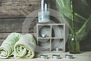 A moment to relax, natural spa and wellness background, raw wood, candles, blue and green colors