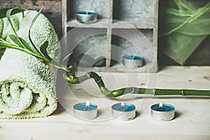 A moment to relax, natural spa and wellness background, raw wood, candles, blue and green colors