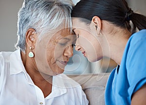 Moments like these. Closeup shot of an attractive young female nurse sharing an intimate moment with her senior patient.