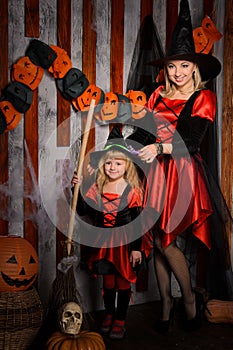 Mommy and little daughter in halloween style