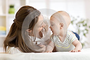 Mommy loving newborn child. Mother communicates with her baby. photo